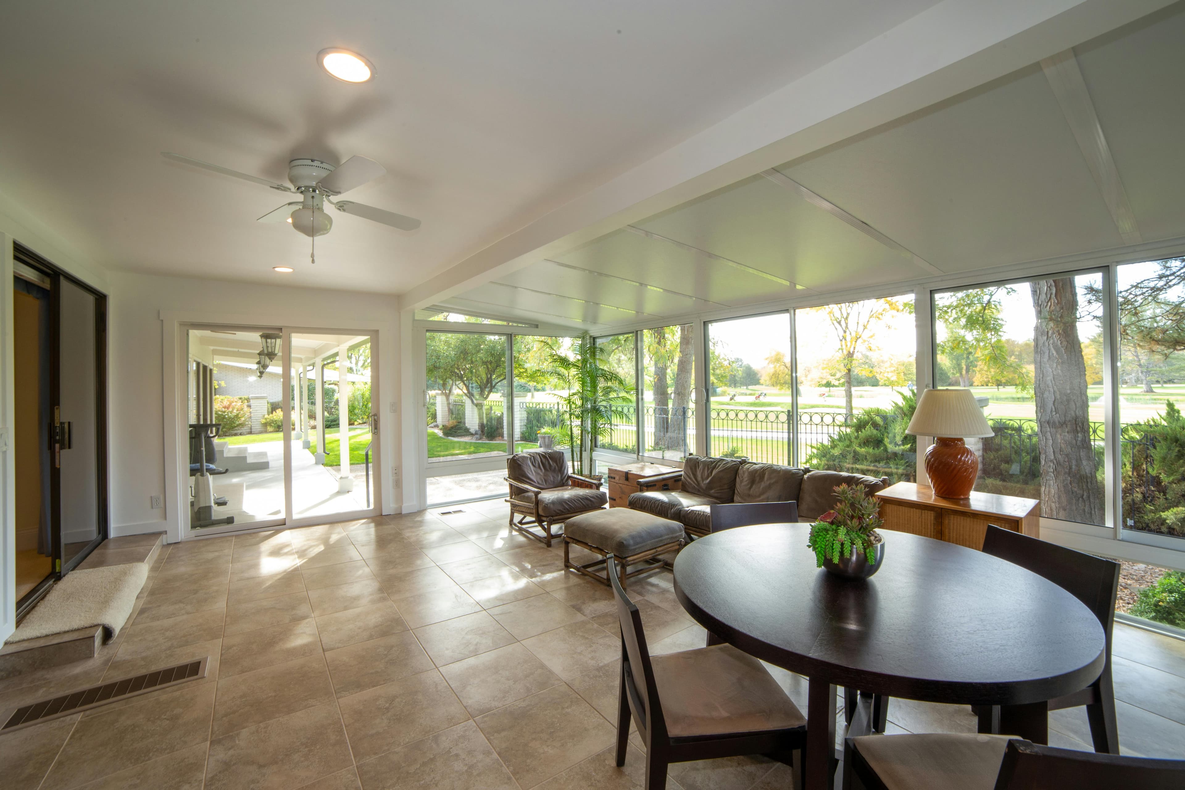 Sunlit residential sunroom with large windows