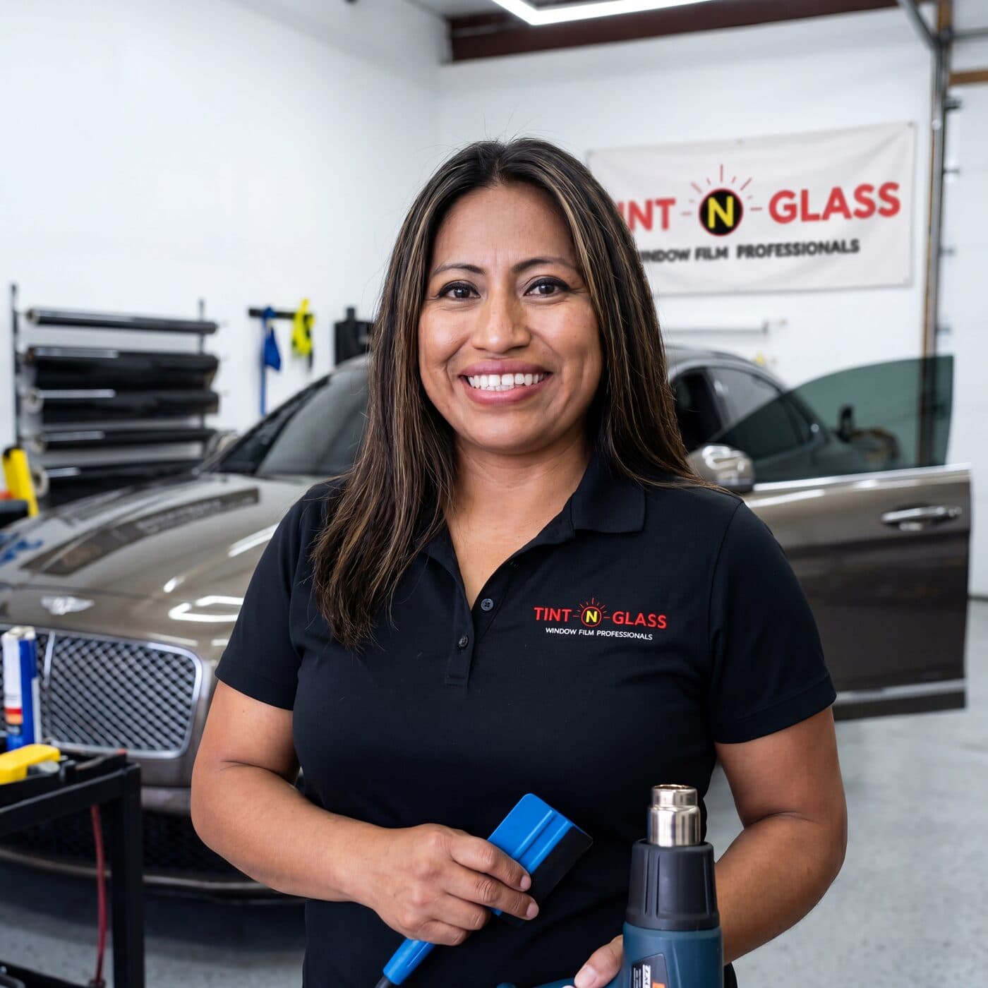 Perla Taylor portrait inside the Tint N Glass shop
